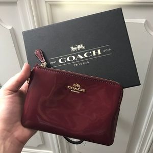 Burgundy patent Coach wristlet